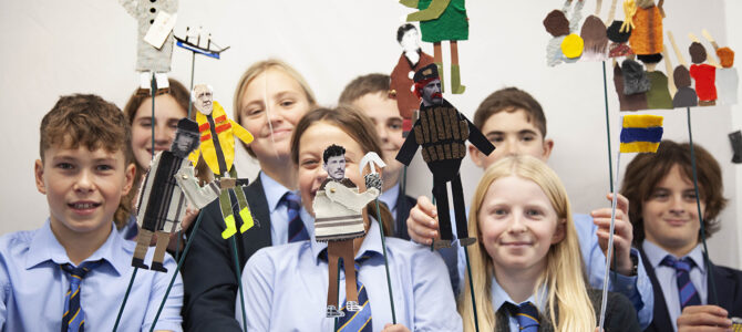 budehaven students holding puppets to tell story of Bude Storm Tower